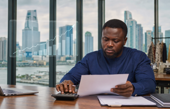 Nigerian business owner reviewing loan costs as high interest rates pressure the economy